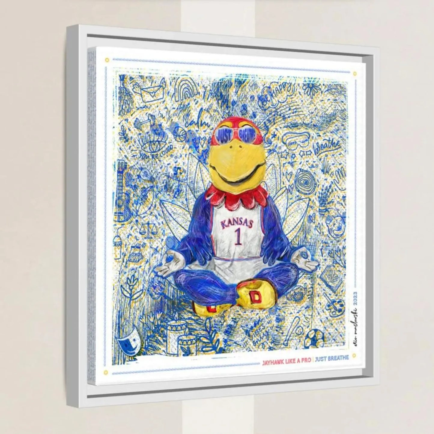 A framed artwork depicting a cartoon character wearing a Kansas University jersey and sunglasses, sitting in a meditative pose with a relaxed expression.