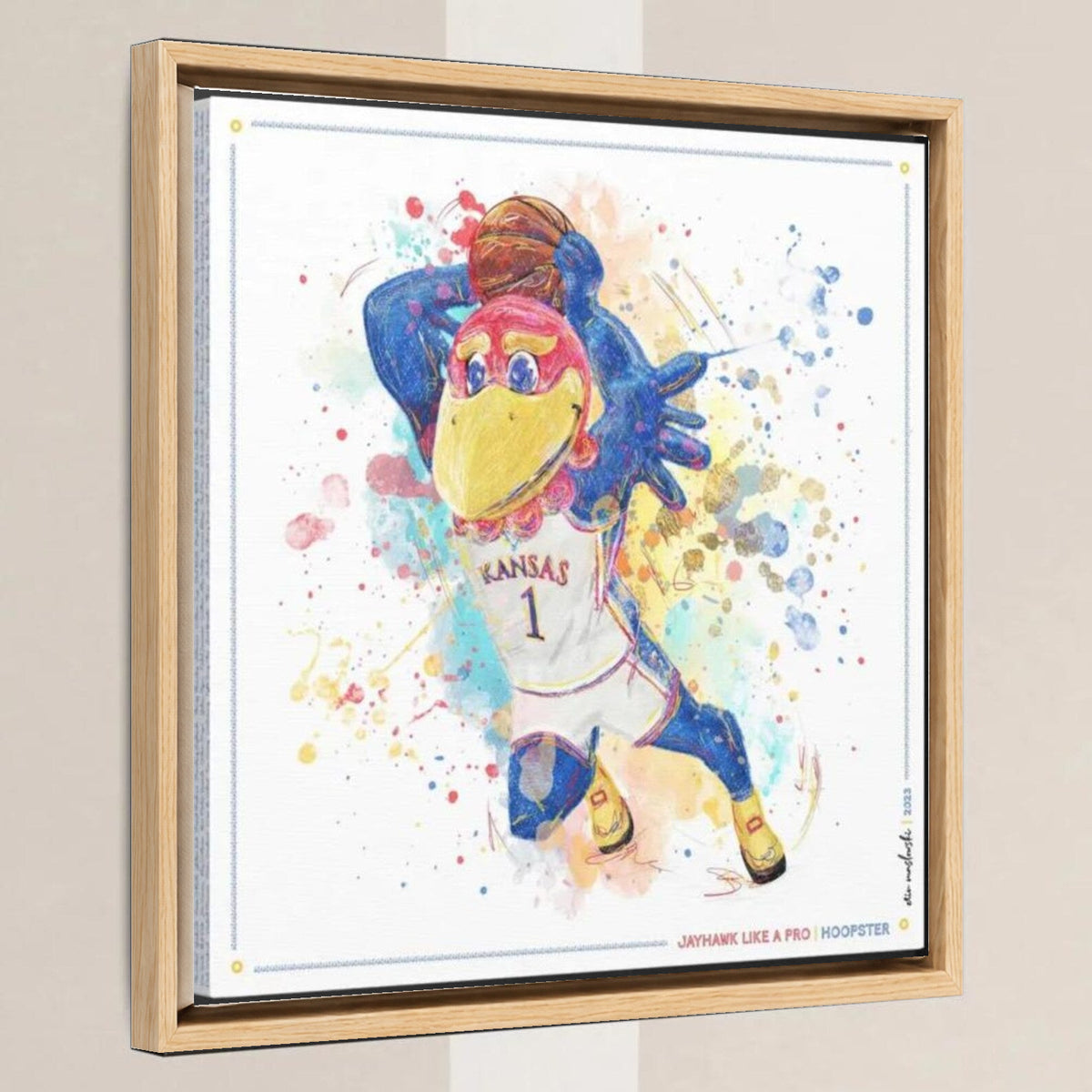 KU Jayhawk Hoopster Art: University of Kansas Basketball Splatter Paint Canvas Print in a light oak float frame