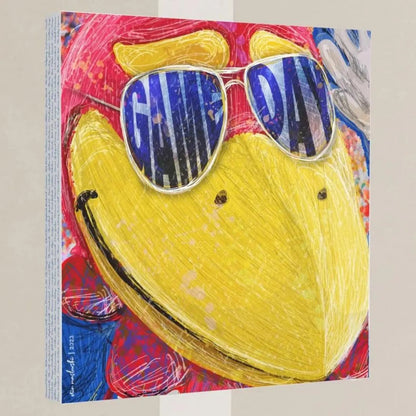 The image is a vibrant and colorful painting featuring a large yellow bird wearing sunglasses with the word "GAME DAY" written on them.
