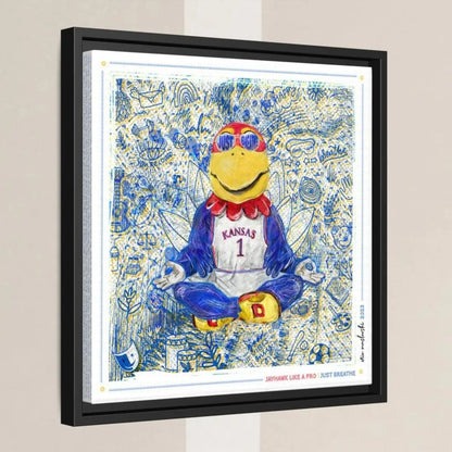 A framed artwork depicting a cartoon character wearing a Kansas jersey and sunglasses, sitting in a meditative pose with a relaxed expression.