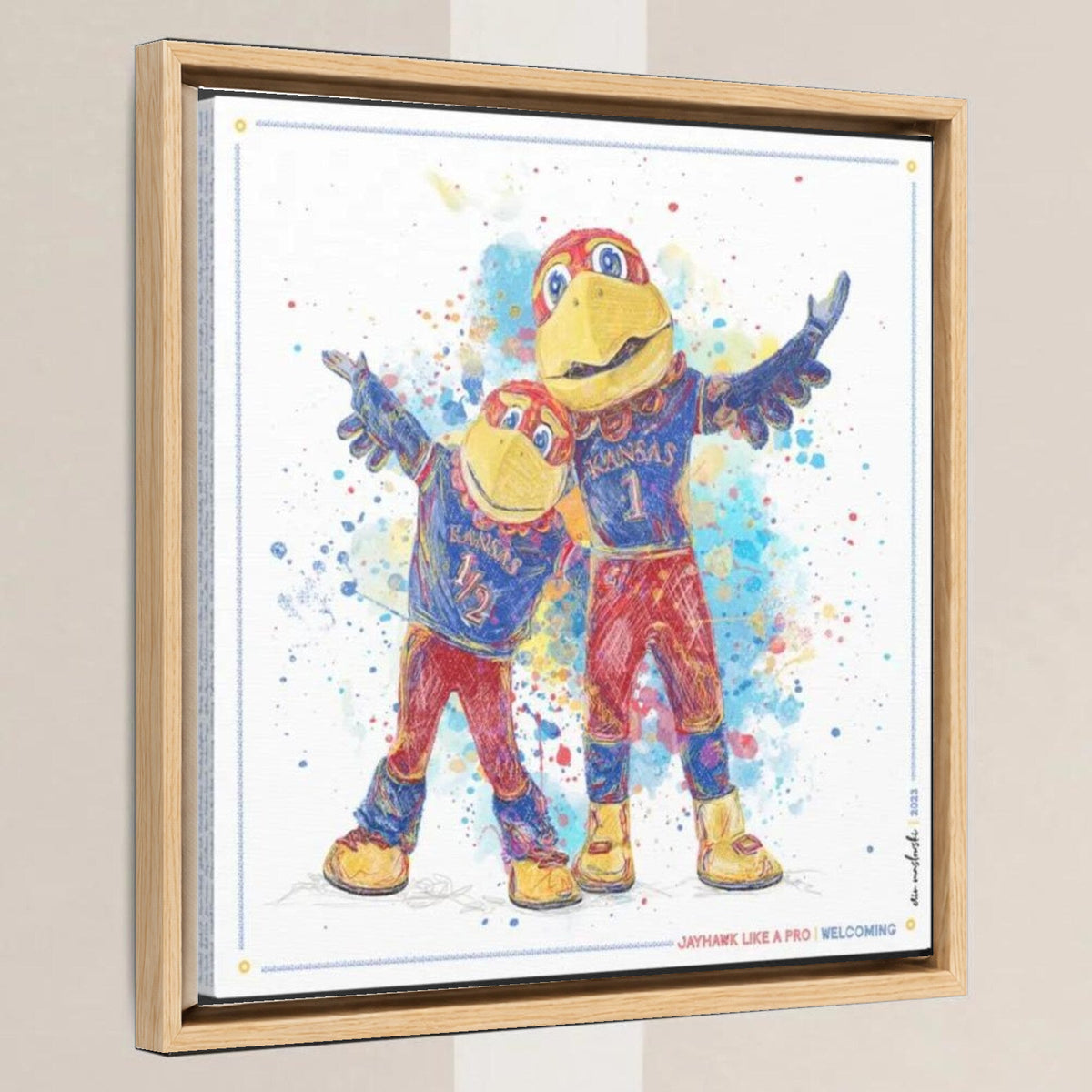 KU Jayhawk Welcoming Art: University of Kansas Big Jay and Baby Jay Splatter Canvas Print in a light oak float frame